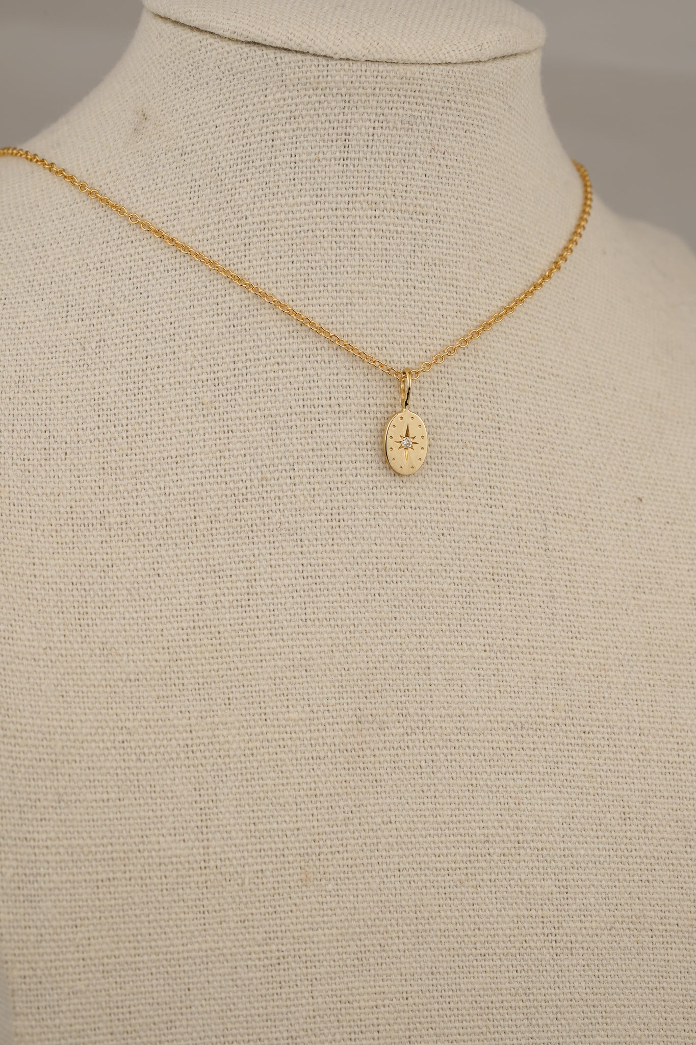 Solid gold tiny oval pendant with natural diamond