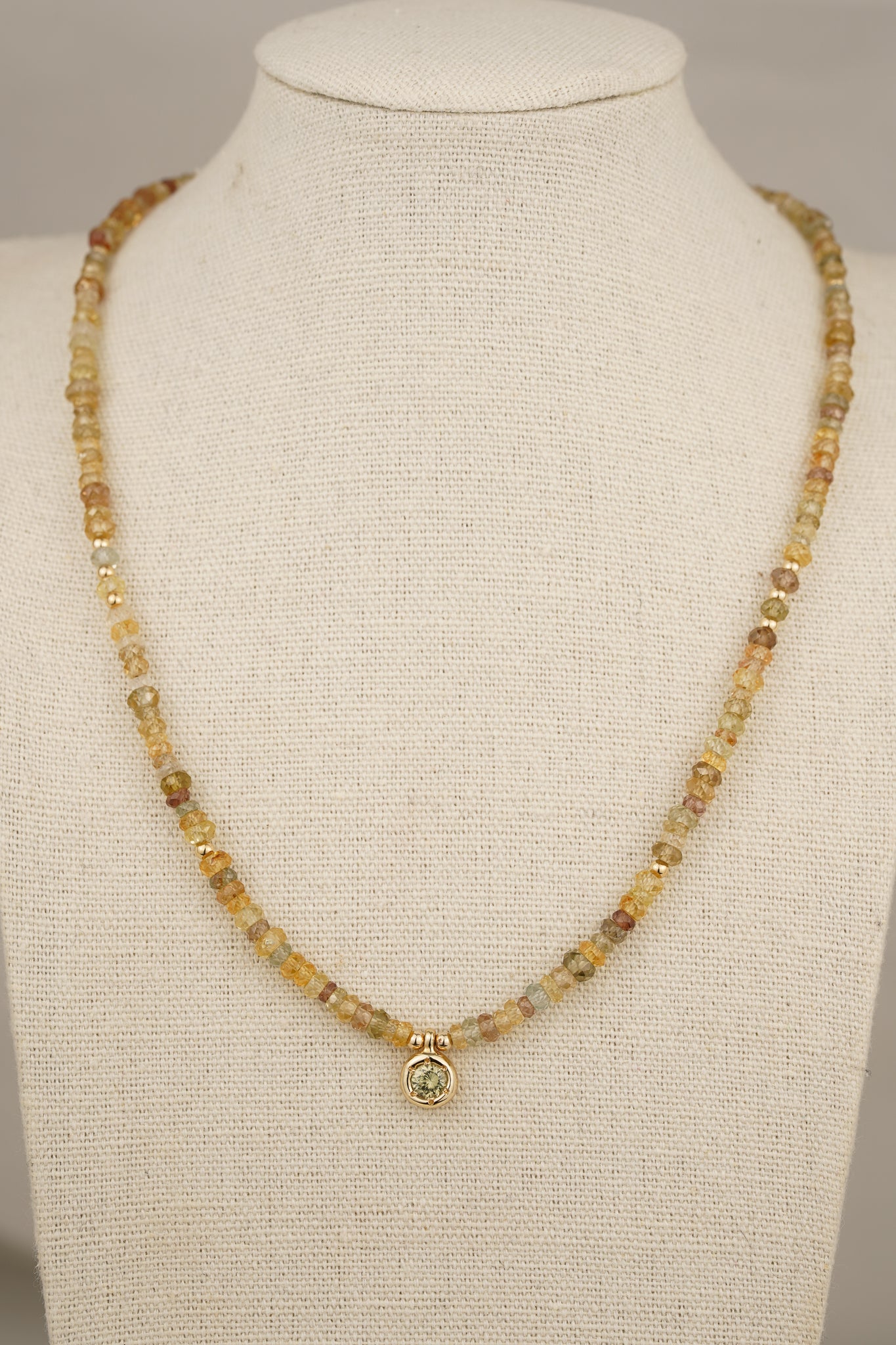 Solid gold mixed-colour zircon beaded necklace with green zircon pendant