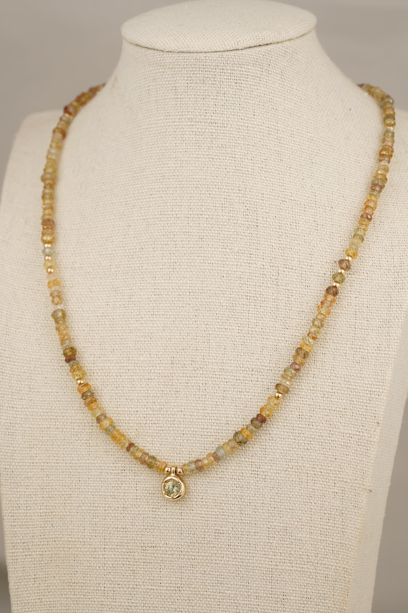 Solid gold mixed-colour zircon beaded necklace with green zircon pendant