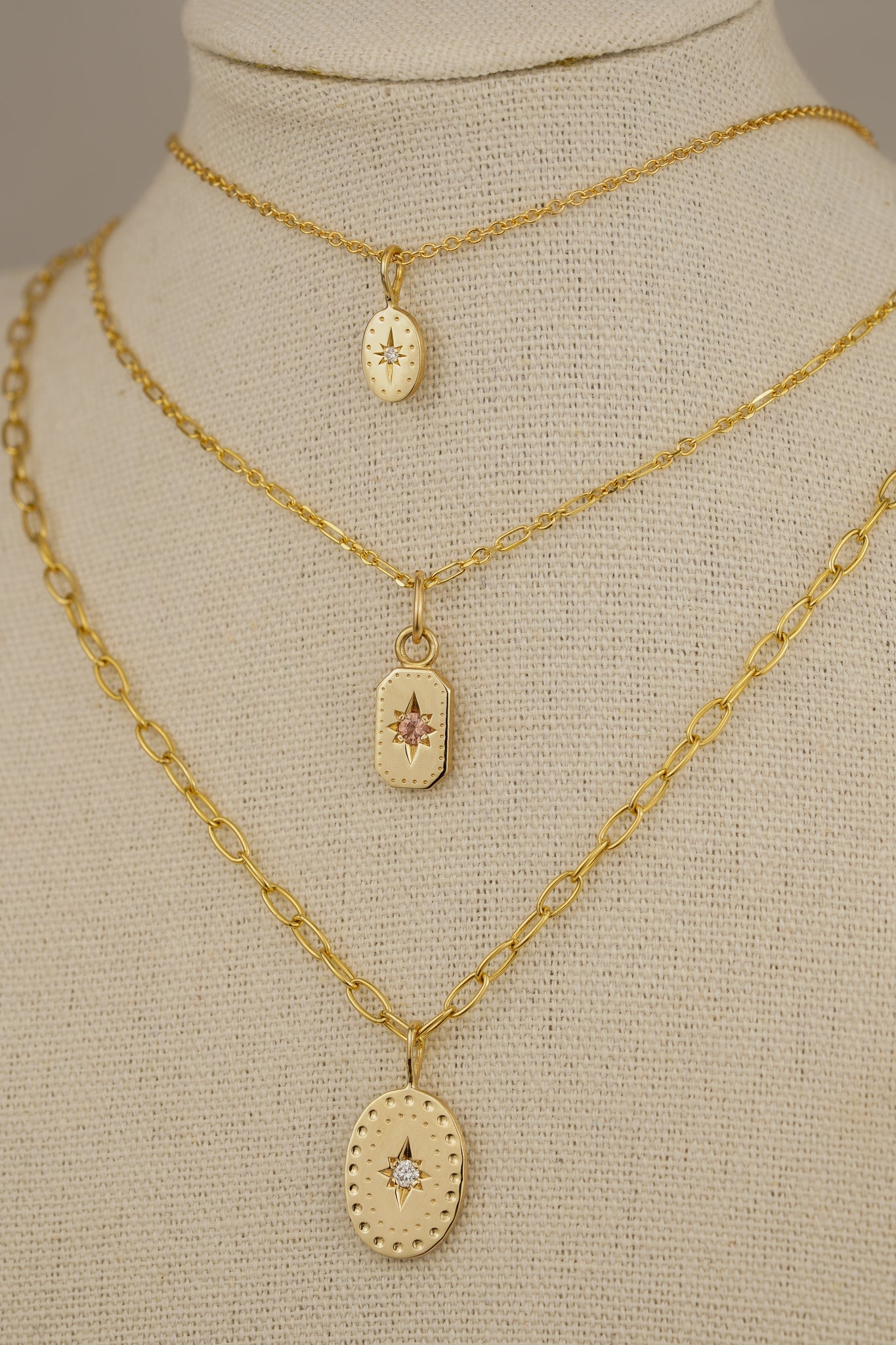 Solid gold emerald cut pendant with peach sapphire