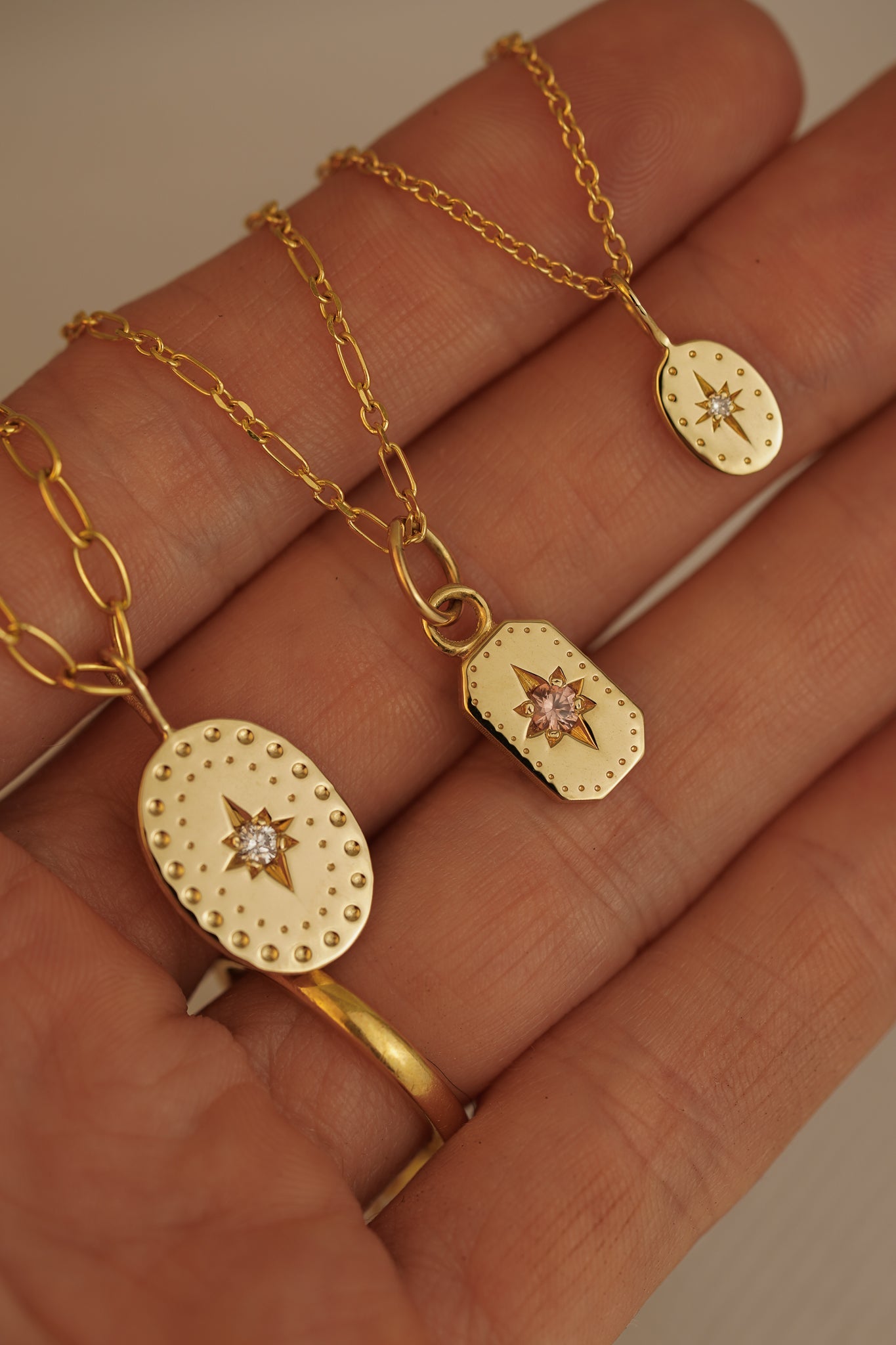 Solid gold emerald cut pendant with peach sapphire