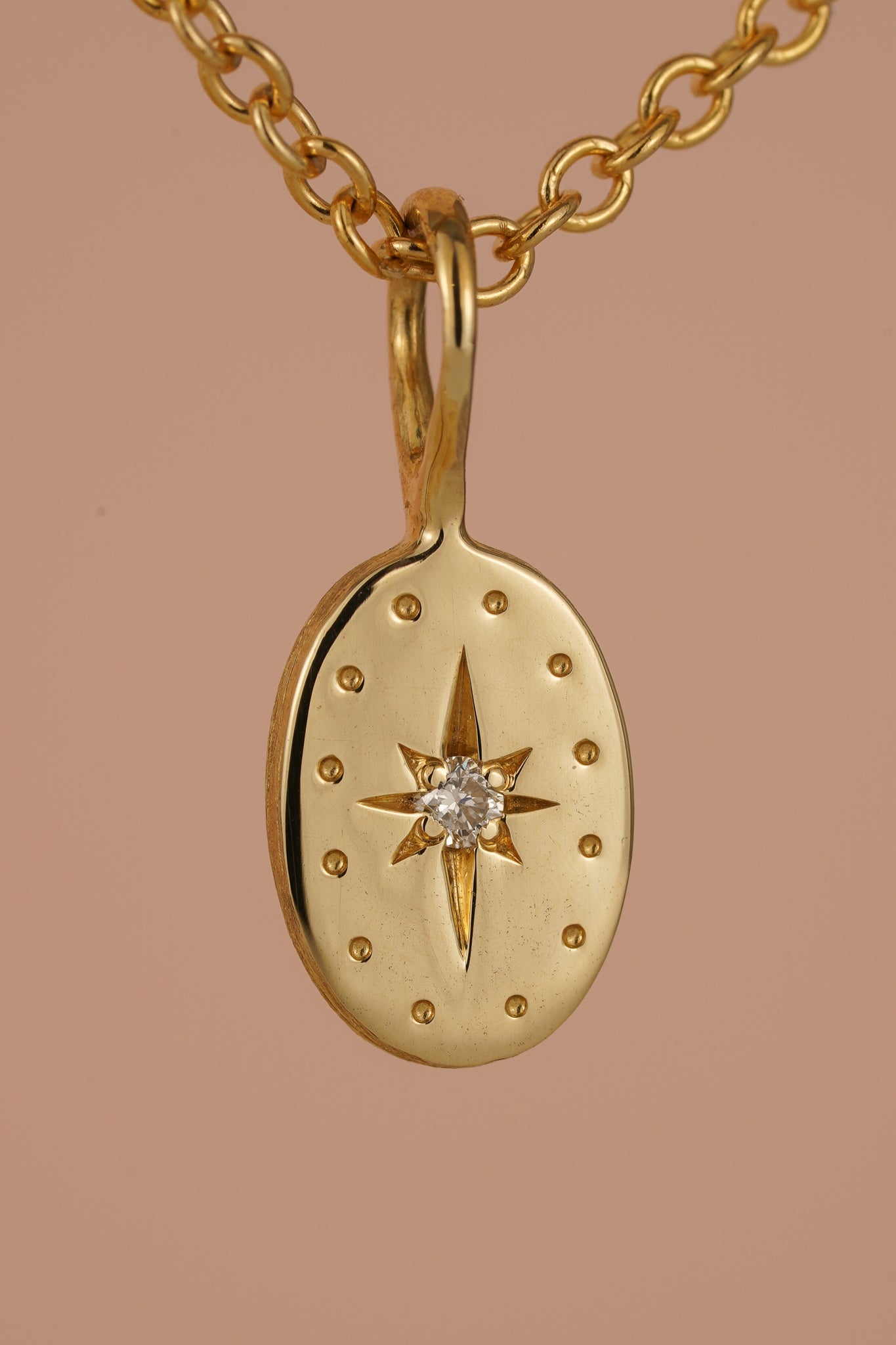 Solid gold tiny oval pendant with natural diamond