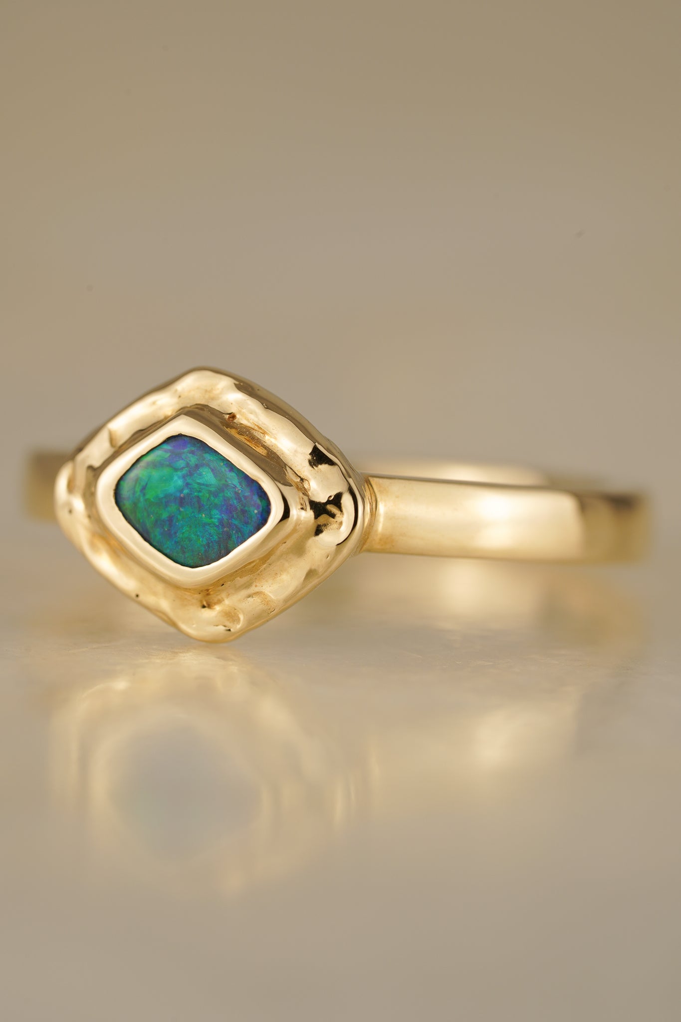 Solid gold blue-green boulder opal ring