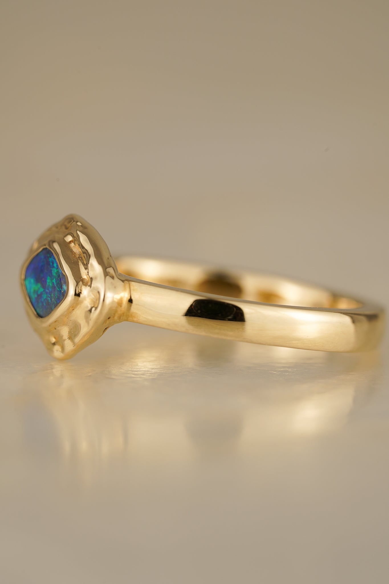 Solid gold blue-green boulder opal ring