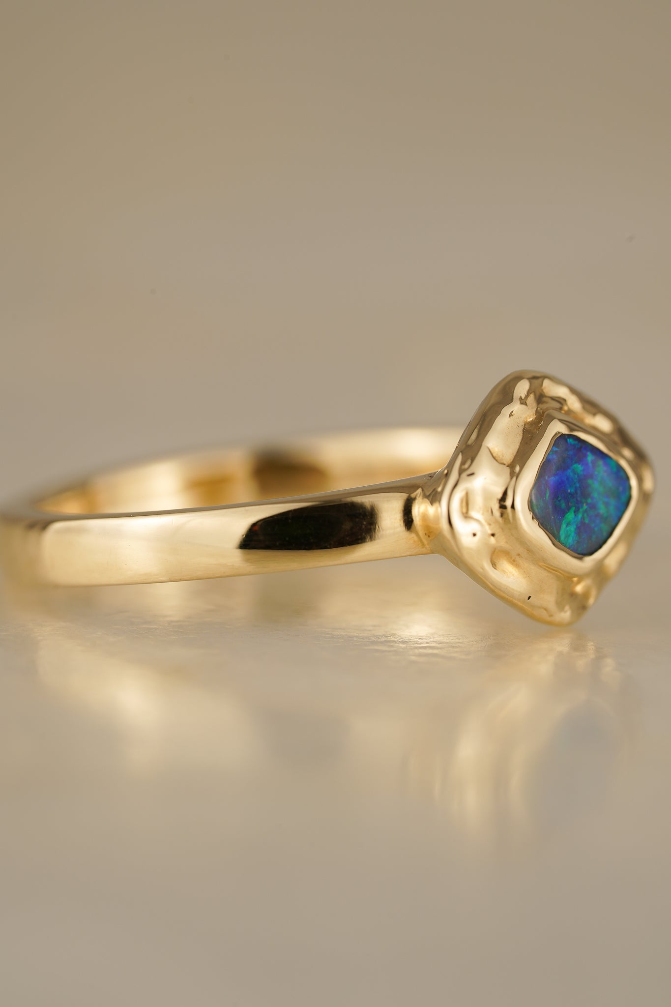 Solid gold blue-green boulder opal ring