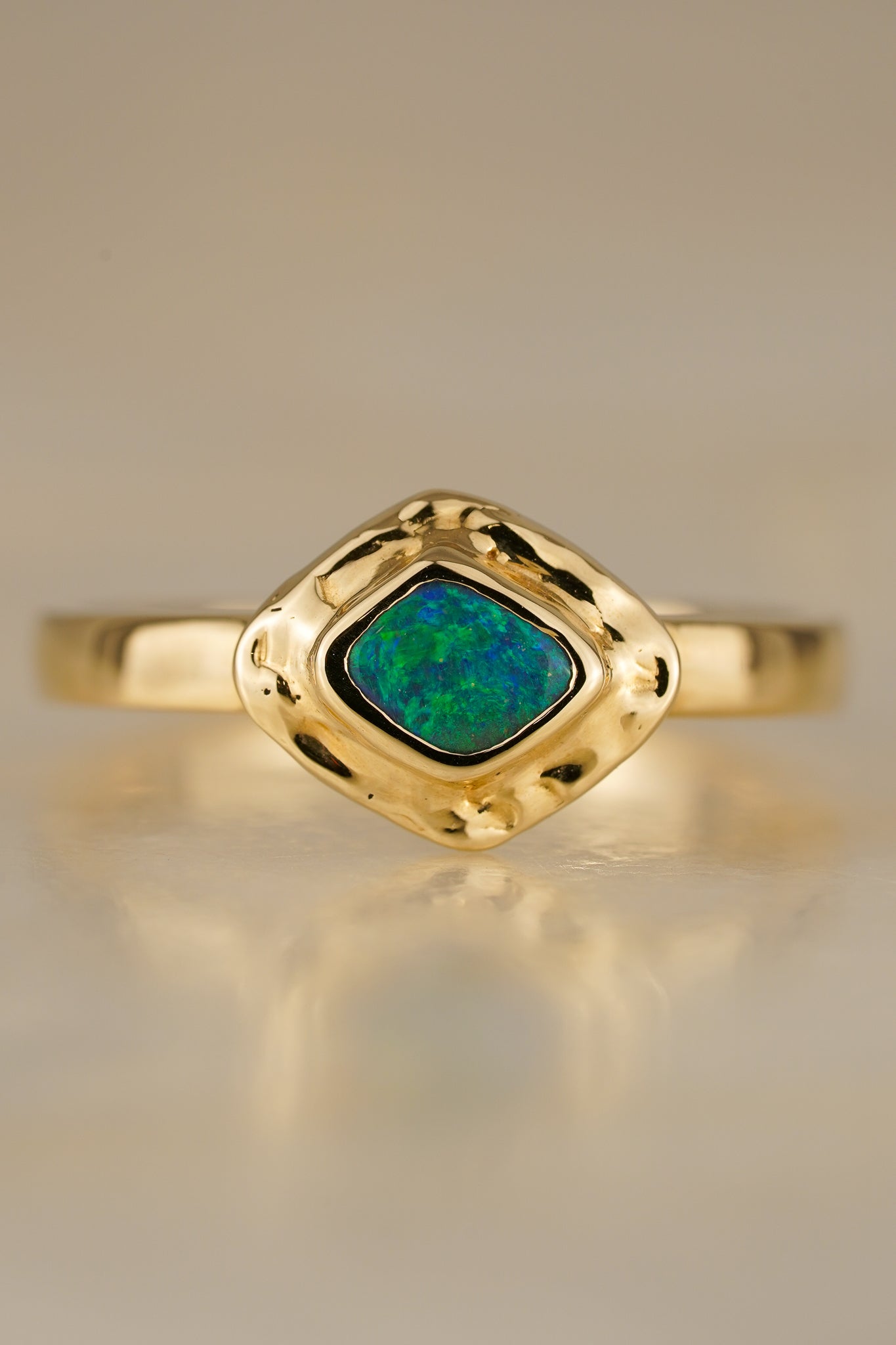 Solid gold blue-green boulder opal ring