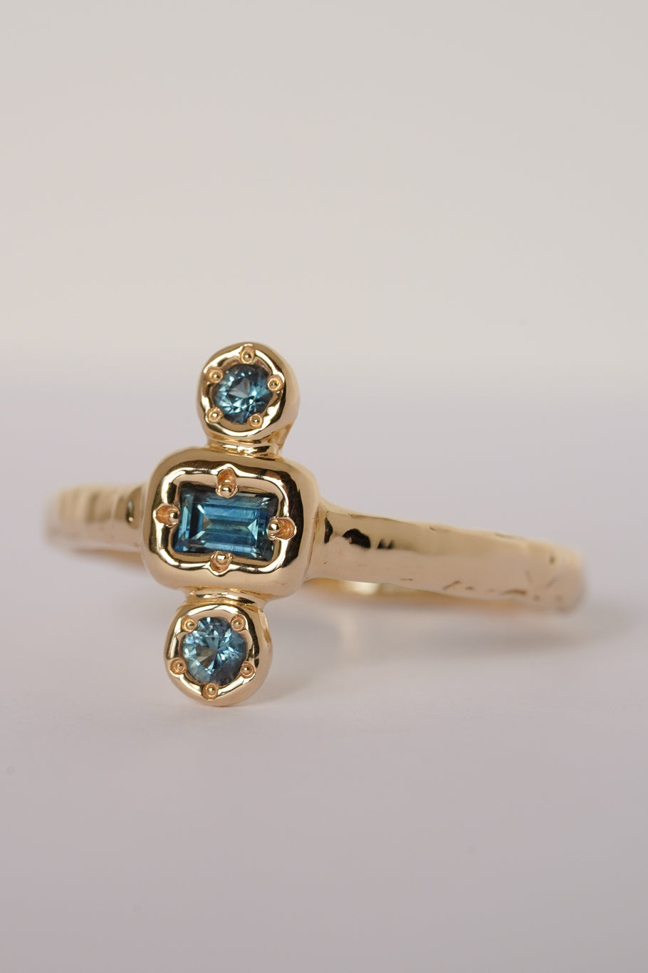 Solid gold blue sapphire trilogy ring