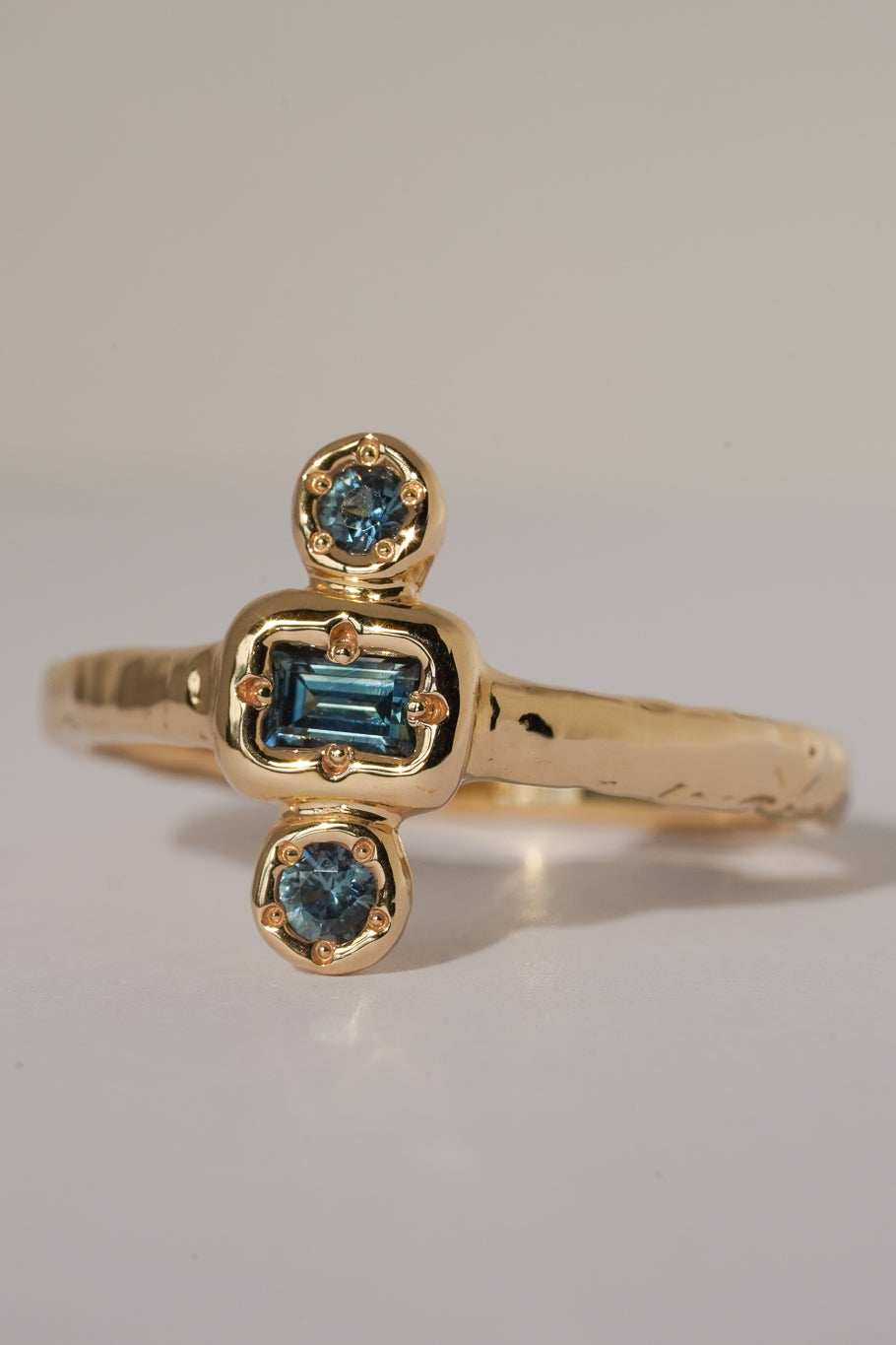 Solid gold blue sapphire trilogy ring