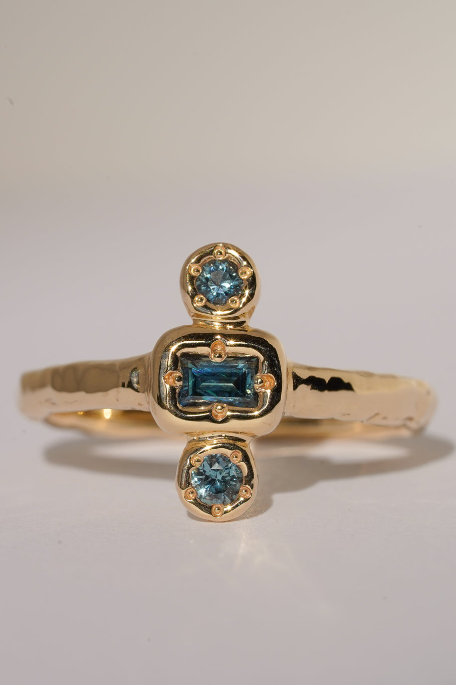 Solid gold blue sapphire trilogy ring