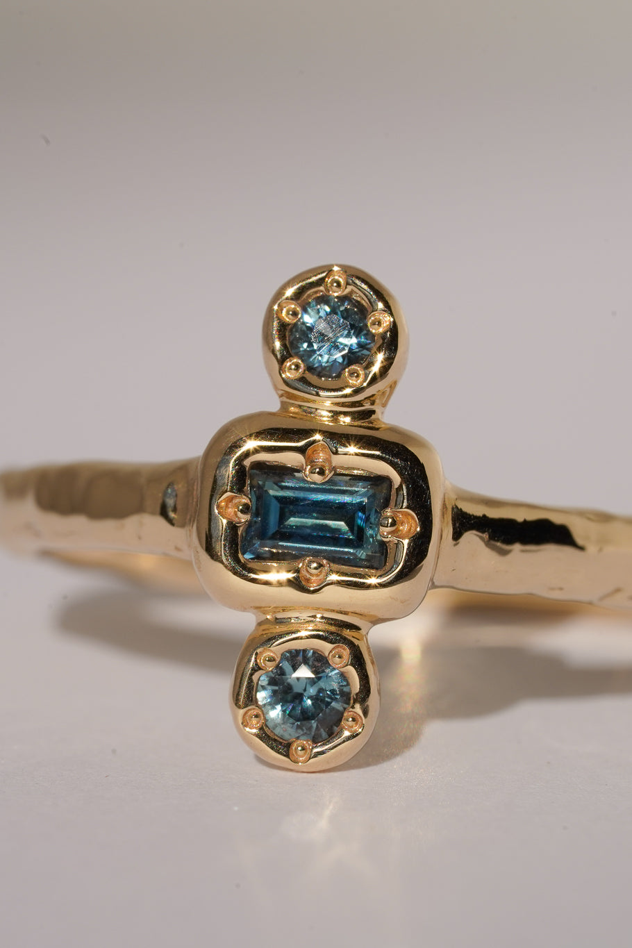 Solid gold blue sapphire trilogy ring