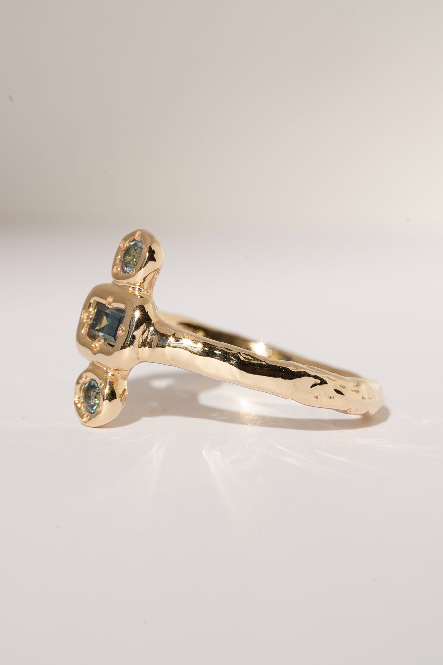 Solid gold blue sapphire trilogy ring