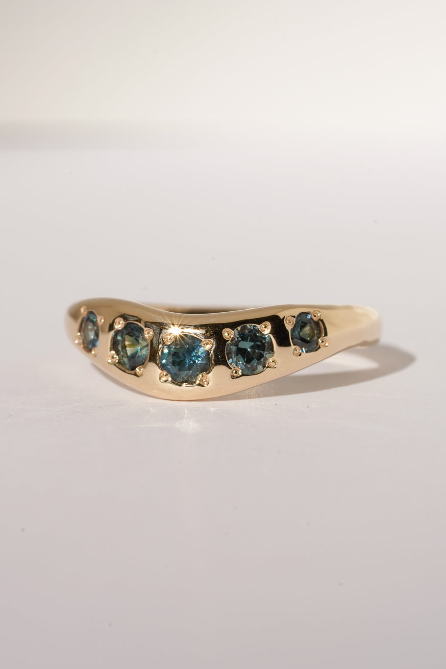 Solid gold teal sapphire stacking band