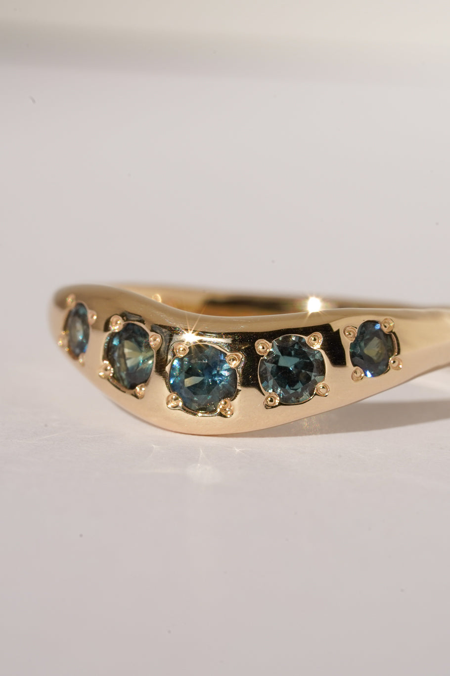 Solid gold teal sapphire stacking band