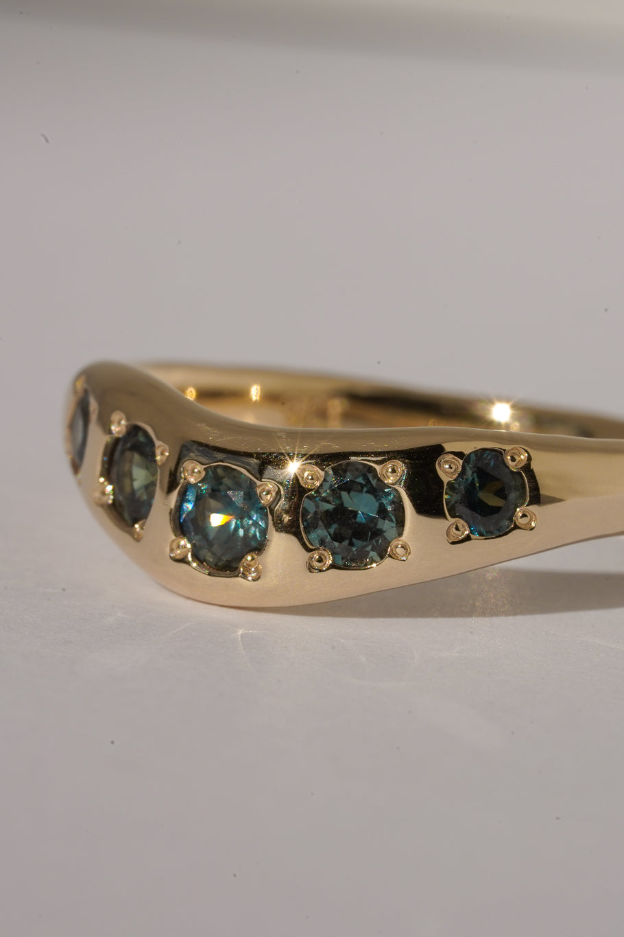 Solid gold teal sapphire stacking band