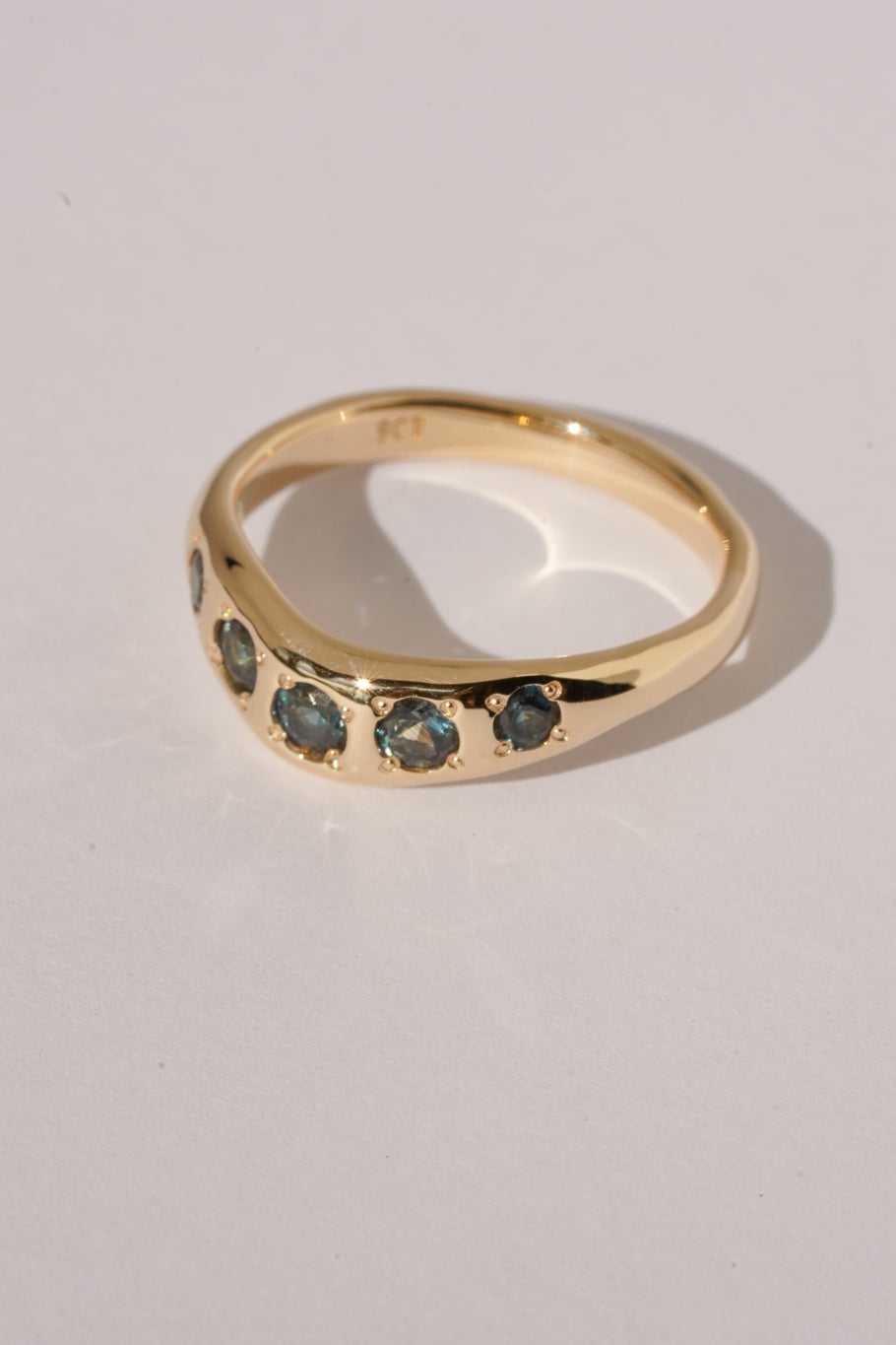 Solid gold teal sapphire stacking band