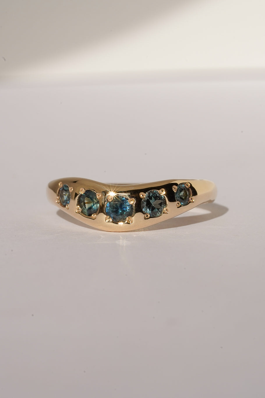 Solid gold teal sapphire stacking band