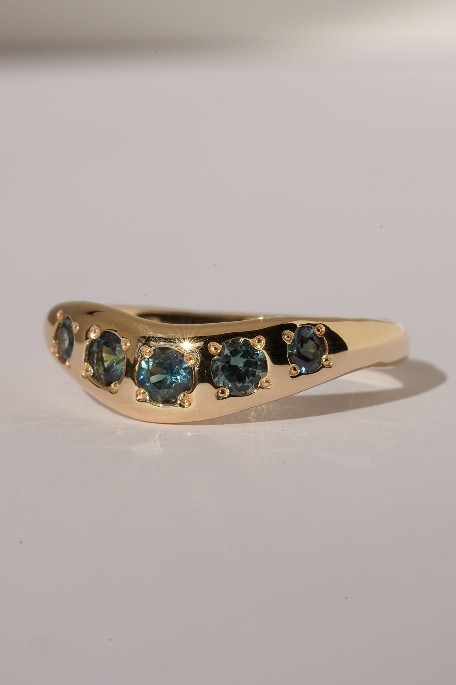 Solid gold teal sapphire stacking band