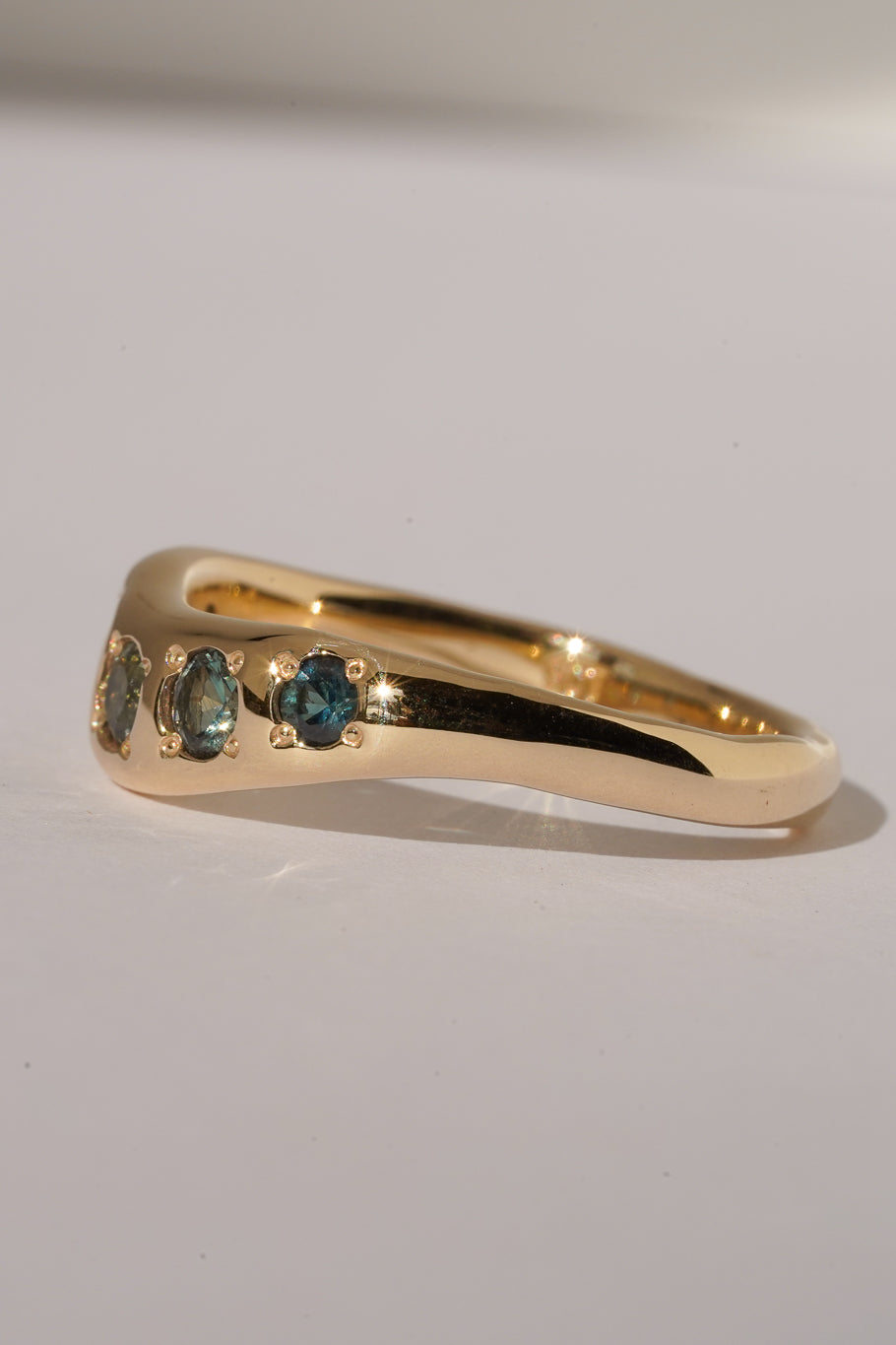 Solid gold teal sapphire stacking band
