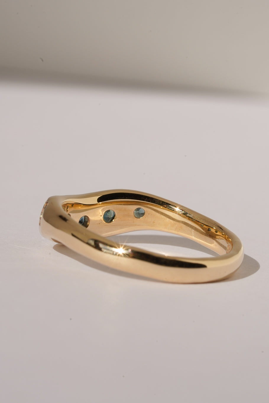 Solid gold teal sapphire stacking band
