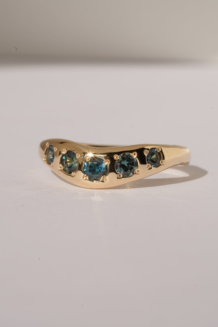 Solid gold teal sapphire stacking band