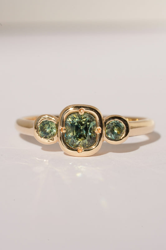 Solid gold green sapphire trilogy ring