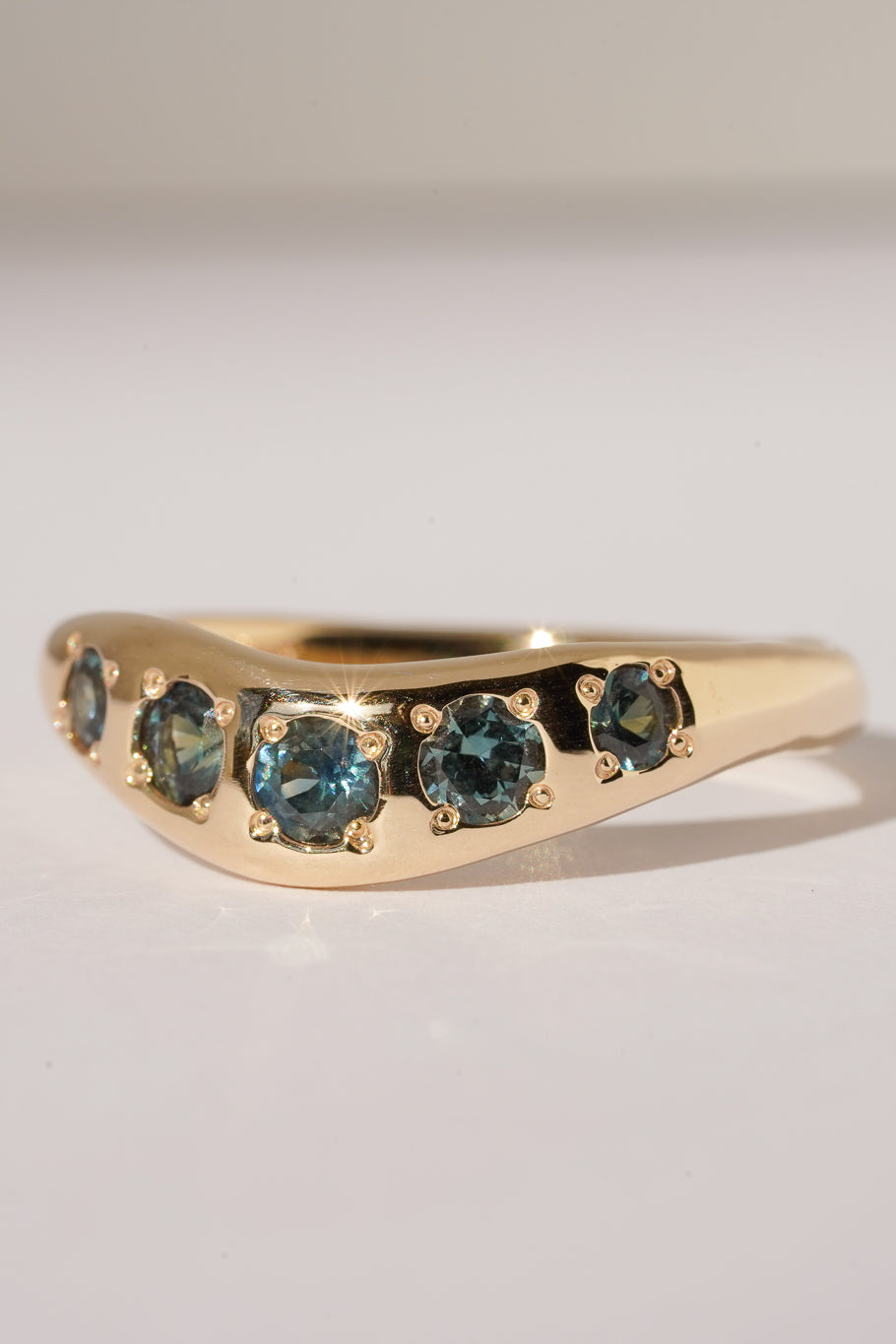 Solid gold teal sapphire stacking band